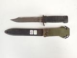 pair of knives on a white surface with a tag on it