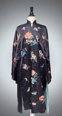an image of a black robe with flowers on it on a mannequin