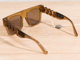sunglasses on a wooden table with a string attached to them