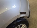 a close up of a silver car with a sticker on the side of it