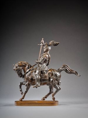 statue représentant un homme à cheval, muni d'une lance, posée sur un socle en bois