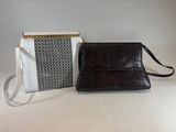 a white and black purse next to a black and white purse