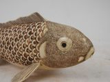 a small wooden fish that is sitting on a table