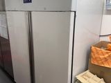 a refrigerator that is sitting in the middle of a room
