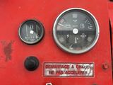a close up of a gauge on a red machine