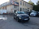 a small black car parked in front of a building
