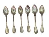 six silver spoons are lined up in a row on a white surface