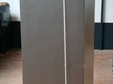 two refrigerators sitting on a pallet in a warehouse