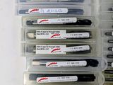 a lot of pens that are in a plastic container