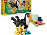 un oiseau Lego Creator tenant une fleur devant une boîte