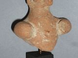an image of a statue of a man on a wooden base