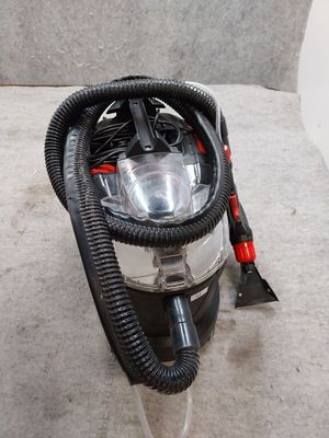 a close up of a vacuum cleaner with a hose on the floor