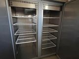 two open refrigerators in a small kitchen with no doors