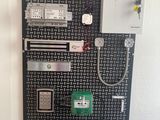 a picture of a wall mounted board with various electrical components