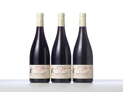 three bottles of wine sitting on top of a table