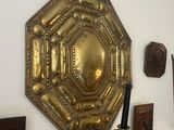 a wall with a mirror and a candle holder on it
