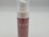 a close up of a bottle of moist cream on a white surface