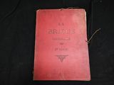 an old book sitting on top of a black cloth covered table