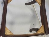 a wooden chair that has a seat made of wood
