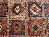 a close up of a rug with many different colors and patterns