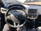 a man sitting in the driver ' s seat of a car
