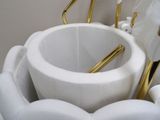 a white toilet with gold handles in a bathroom