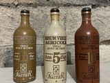 three bottles that are sitting next to each other on a table