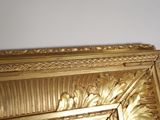 a picture of a gold picture frame on the wall
