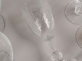 many empty wine glasses sitting on a white table