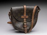 a close up of a brown and brown purse on a white surface