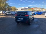 cars are parked in a parking lot in front of a building