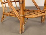 a chair made out of bamboo sticks on a concrete floor