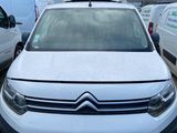 a white citrole parked in a lot next to other cars