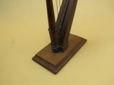 a small wooden harp on a stand on a table