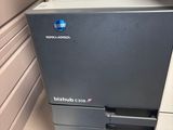 a printer that is sitting on the floor next to a wall