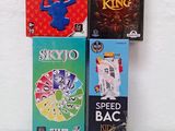 four board games sitting on a white surface