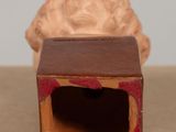 a figurine of a man in a box on a table