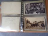 four old postcards in a folder on a table