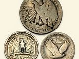 a close up of three different coins on a white surface