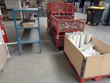 many boxes and carts in a warehouse with a lot of items
