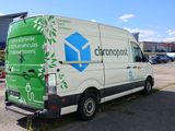 a green and white van parked in a parking lot