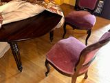 four chairs that are sitting around a table in a room