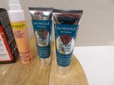 two tubes of lotion and a bottle of lotion sitting on a table