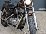 a black motorcycle parked in front of a garage door