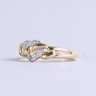 a gold ring with a heart shaped diamond on it