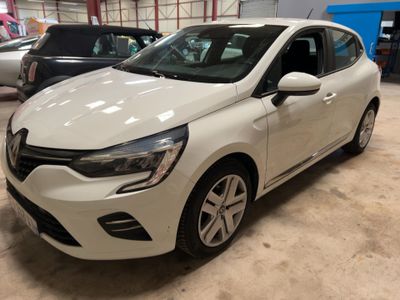 the white car is parked in the garage next to other cars