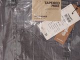 a bag of tapered denim with a tag on it