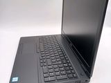 a laptop with a black keyboard on a white surface