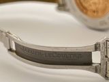a close up of a watch on a white surface
