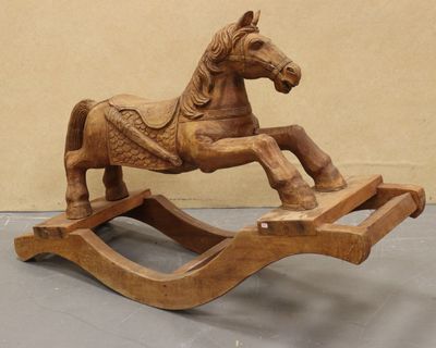 a wooden rocking horse that is sitting on the floor